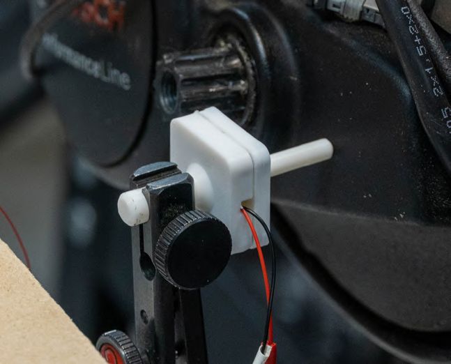 3D-printed sensor finger pressed against the motor